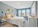 Bright bedroom with large window, modern lighting, and minimalist decor at 8712 Silver Perch Ln, North Charleston, SC 29420