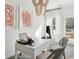 Well-lit home office area features a white desk, comfortable chairs, and stylish artwork at 8712 Silver Perch Ln, North Charleston, SC 29420