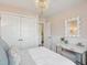 Beautiful bedroom with stylish wainscoting, chandelier, and a large window at 8746 Silver Perch Ln, North Charleston, SC 29420