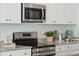 Close-up of a modern kitchen with stainless steel appliances and granite countertops at 8746 Silver Perch Ln, North Charleston, SC 29420