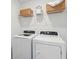 Bright laundry room with a full-size washer and dryer plus ample shelving for storage at 8746 Silver Perch Ln, North Charleston, SC 29420