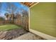 Cozy backyard with brick pavers, green wall, and wooden fence with trees in the background at 9024 Parlor Dr, Ladson, SC 29456