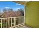 View from balcony shows a green fence and bare trees in the distance at 9024 Parlor Dr, Ladson, SC 29456