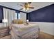 Bedroom features a ceiling fan, white walls, carpet floors and side tables with lamps at 9024 Parlor Dr, Ladson, SC 29456