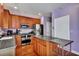 Well-equipped kitchen featuring wood cabinetry, stainless steel appliances, and a functional kitchen island at 9024 Parlor Dr, Ladson, SC 29456