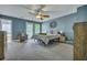 Comfortable main bedroom with a ceiling fan, carpet floors, and ensuite bathroom and walk-in closet at 9024 Parlor Dr, Ladson, SC 29456