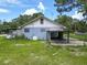 Exterior of a house showing the backyard, carport, and patio area, needing some TLC at 93 Knights Ave, Walterboro, SC 29488