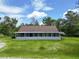 Classic single-story home with a welcoming porch and a lush green lawn under a bright sky at 93 Knights Ave, Walterboro, SC 29488