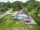 An aerial shot showing a homes backyard with covered area and surrounding green vegetation at 93 Knights Ave, Walterboro, SC 29488