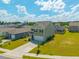 A neighborhood aerial view featuring a charming two-story home with well-manicured lawns and two-car garage at 1032 Peridote Way, Ladson, SC 29456