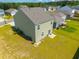 Aerial view showcasing the house, well-maintained backyard, and the surrounding neighborhood at 1032 Peridote Way, Ladson, SC 29456