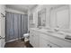 Modern bathroom featuring a double vanity, framed mirrors, storage cabinet, and neutral color palette at 1032 Peridote Way, Ladson, SC 29456