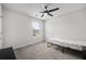 Bright bedroom featuring a ceiling fan, neutral carpet, and a window with pleasant outdoor views at 1032 Peridote Way, Ladson, SC 29456