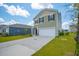 Inviting two-story home with a well-maintained lawn, featuring a two-car garage and classic design elements at 1032 Peridote Way, Ladson, SC 29456