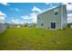 Two-story house with a well-manicured lawn and lush greenery, showing the backyard area at 1032 Peridote Way, Ladson, SC 29456