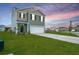 Lovely two-story home features a well-kept lawn and a convenient two-car garage against a vibrant sunset backdrop at 1032 Peridote Way, Ladson, SC 29456