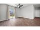 Bright living room with wood floors, ceiling fan, and sliding glass door with backyard access at 1032 Peridote Way, Ladson, SC 29456
