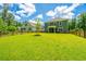 View of the fenced backyard, lush green lawn, and home exterior on a sunny day at 104 Limpkin Ln, Summerville, SC 29483
