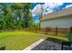 Spacious backyard with green grass, a wooden fence, and a stone paver patio at 104 Limpkin Ln, Summerville, SC 29483