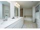 Bright bathroom with double vanity, soaking tub, and tiled shower with glass door at 104 Limpkin Ln, Summerville, SC 29483