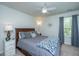 Comfortable bedroom with a ceiling fan, gray bedding and natural light from the nearby window at 104 Limpkin Ln, Summerville, SC 29483