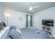 Bedroom with ceiling fan, comfy gray bedding, a white bookcase and a TV at 104 Limpkin Ln, Summerville, SC 29483