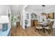 Bright dining room with hardwood floors, stylish lighting, and elegant decor at 104 Limpkin Ln, Summerville, SC 29483