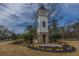 Community entrance showcasing the architectural detail of the tower and landscaping; a picturesque welcome at 104 Limpkin Ln, Summerville, SC 29483