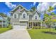Inviting two-story home featuring a covered porch and well-maintained landscaping at 104 Limpkin Ln, Summerville, SC 29483