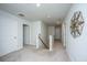 Hallway with neutral carpet, white walls, and doors, leading to the staircase at 104 Limpkin Ln, Summerville, SC 29483