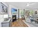 Bright living room with fireplace, mounted television, and access to outdoor patio at 104 Limpkin Ln, Summerville, SC 29483
