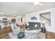 Open-concept living room with hardwood floors, stylish furniture, and seamless kitchen access at 104 Limpkin Ln, Summerville, SC 29483