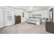 Spacious main bedroom with light carpet, lots of natural light and stylish furniture at 104 Limpkin Ln, Summerville, SC 29483