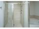 Luxurious tiled walk-in shower with glass door and adjacent soaking tub in bathroom at 104 Limpkin Ln, Summerville, SC 29483