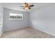 This bedroom features a window providing natural light, carpet, and a ceiling fan at 107 Hickory Ln # C, Ladson, SC 29456