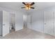 Cozy bedroom with carpet, ceiling fan, adjacent bathroom, and multiple closet doors at 107 Hickory Ln # C, Ladson, SC 29456