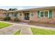 Inviting complex entrance with brick facade, green shutters, and well-manicured landscaping at 107 Hickory Ln # C, Ladson, SC 29456