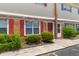 Inviting townhouse features brick facade, red shutters, green landscaping, and an inviting entryway at 107 Hickory Ln # C, Ladson, SC 29456