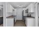Well-appointed kitchen with white cabinetry, stainless steel appliances, and sleek countertops at 107 Hickory Ln # C, Ladson, SC 29456