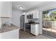 Efficient kitchen with white cabinetry, stainless steel appliances, and access to outdoor patio at 107 Hickory Ln # C, Ladson, SC 29456