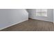 Bright living room features new laminate flooring, neutral paint, and a large window at 107 Hickory Ln # C, Ladson, SC 29456