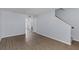 Spacious living area with laminate flooring, neutral paint, and access to the staircase at 107 Hickory Ln # C, Ladson, SC 29456