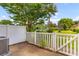 Outdoor patio area with white picket fence and a view of the well maintained green common area at 107 Hickory Ln # C, Ladson, SC 29456