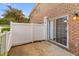 Cozy outdoor patio area with white privacy fence and sliding glass door for easy indoor-outdoor living at 107 Hickory Ln # C, Ladson, SC 29456