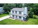 Aerial view of a charming home with a well-maintained lawn and mature trees surrounding the property at 107 Sugarpine Pl, Summerville, SC 29486