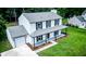 Aerial view of a two-story home featuring a covered porch and attached garage in a wooded neighborhood at 107 Sugarpine Pl, Summerville, SC 29486