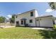 White home featuring a wooden deck, lush green grass, and bright blue skies at 107 Sugarpine Pl, Summerville, SC 29486