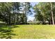 Large green backyard featuring mature trees and luscious green grass at 107 Sugarpine Pl, Summerville, SC 29486