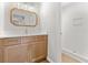 Bright bathroom with a wood vanity, white countertop, ornate mirror, and tiled shower at 107 Sugarpine Pl, Summerville, SC 29486