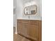 Bathroom featuring light wood vanity, white countertop, modern fixtures, and ornate mirror at 107 Sugarpine Pl, Summerville, SC 29486